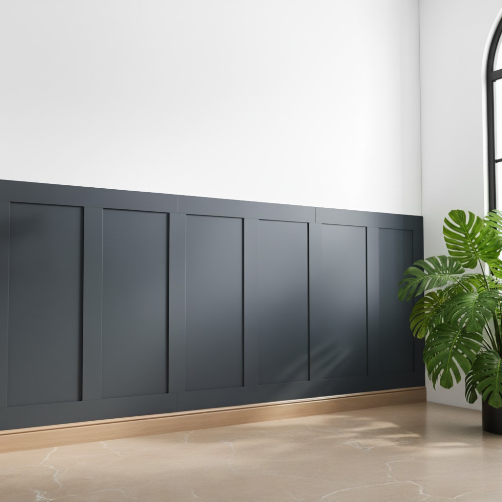 Wall finished with Lunaire Works panelling, painted dark and styled with a plant